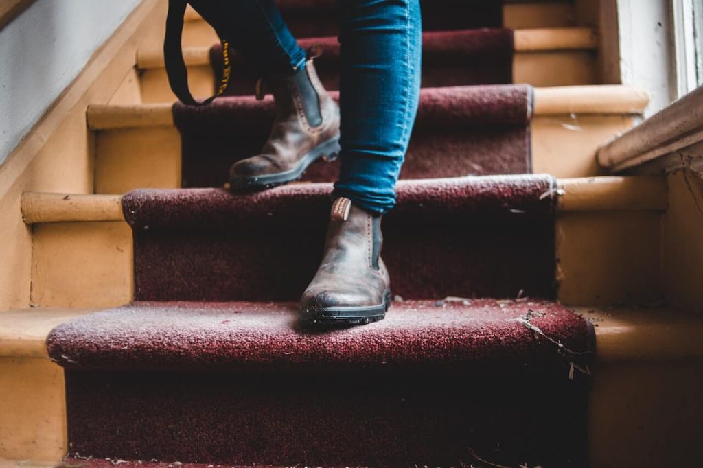 walking down dirty carpeted stairs