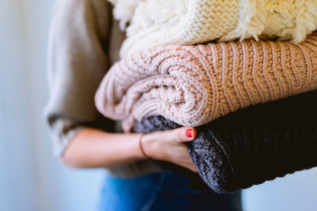 carrying folded clothes